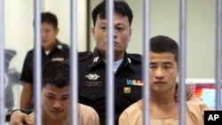 Myanmar migrants Win Zaw Htun, right, and Zaw Lin, left, both 22, are escorted by officials after their guilty verdict at court in Koh Samui, Thailand, Thursday, Dec. 24, 2015.