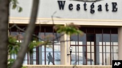 A Kenyan soldier runs through a corridor on an upper floor, shortly before an explosion was heard, at the Westgate Mall in Nairobi, Kenya, Sept. 24, 2013. 