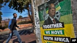 A man walks past an election poster of Jacob Zuma's African National Congress (ANC) party in the Soweto township of Johannesburg, South Africa Friday, May 9, 2014. 