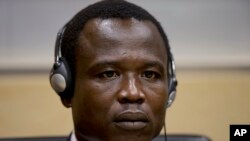 Dominic Ongwen, a Ugandan commander in warlord Joseph Kony's feared militia, waits for the judge to arrive as he made his first appearance at the International Criminal Court in The Hague, Netherlands, Jan. 26, 2015.