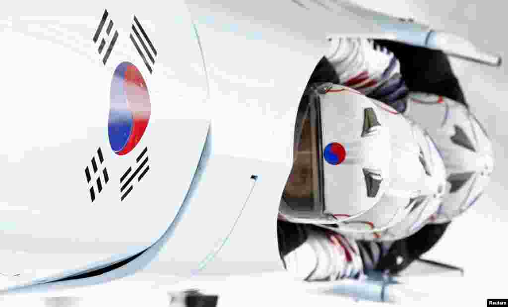 South Korea's pilot Kim Dong-hyun (front) and his teammates speed down the track during a four-man bobsleigh training session at the Sanki Sliding Center in Rosa Khutor, near Sochi, Feb. 20, 2014. 