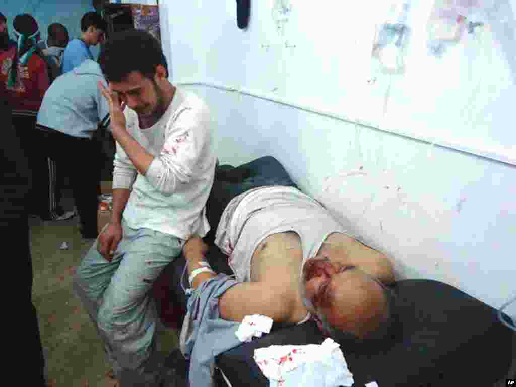 Wounded men in the Sunni district of Bab Amro in Homs, February 8, 2012. (Reuters)