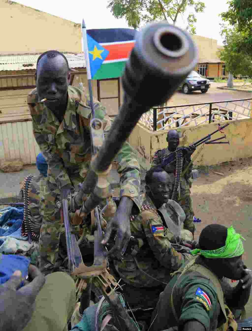 A South Sudan army soldier stands next to a machine gun mounted on a truck in Malakal on December 30, 2013 a few days after retaking the town from opposition forces.