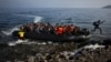 An Afghan migrant jumps off an overcrowded raft onto a beach in the island of Lesbos, Greece, Oct. 19, 2015.