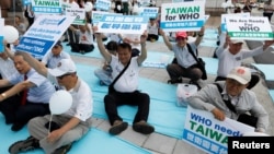 FILE - Protesters take part in a rally in Taipei against Taiwan being excluded from U.N.'s annual World Health Assembly in Geneva, May 21, 2017.