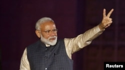 Indian Prime Minister Narendra Modi gestures toward his supporters after the election results at Bharatiya Janata Party (BJP) headquarter in New Delhi, May 23, 2019.