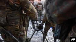 Pejuang Batalion Azov Battalion bersiap menembakkan senjata anti-tank di kota Shyrokyne, Ukraina timur (23/3). (AP/Mstyslav Chernov)