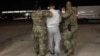 This screenshot from video provided by the U.S. Defense Department shows one of the detained migrants arriving at Naval Station Guantanamo Bay on Feb. 4, 2025.