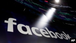 The logo for Facebook appears on screens at the Nasdaq Market Site in New York's Times Square, March 29, 2018. 