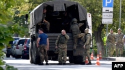 FILE - Russian servicemen get into a truck in Southern Russian city of Rostov-on-Don on Sept. 7, 2023, prior to Russia's local elections.