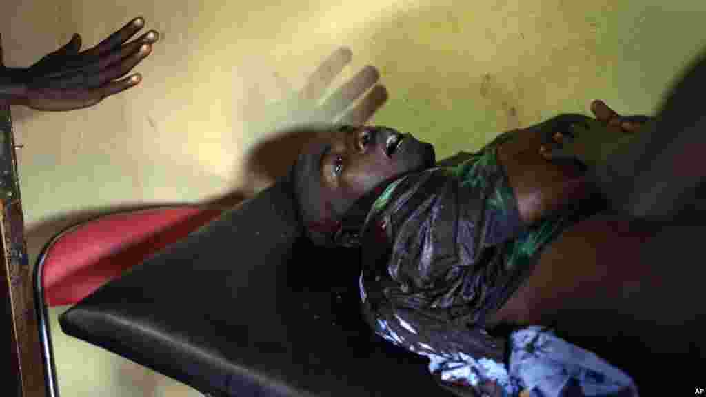 A wounded demonstrator waits for treatment in a small clinic in the Musaga district of Bujumbura, May 4, 2015. 