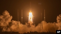 In this Nov. 24, 2020, file photo, a Long March-5 rocket carrying the Chang'e 5 lunar mission lifts off at the Wenchang Space Launch Center in Wenchang in southern China's Hainan Province. (AP Photo/Mark Schiefelbein, File)