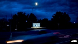 A car passes by Facebook's corporate headquarters location in Menlo Park, California, on March 21, 2018.
