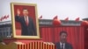 In this Tuesday, Oct. 1, 2019 file photo, participants cheer beneath a large portrait of Chinese President Xi Jinping during a parade to commemorate the 70th anniversary of the founding of Communist China in Beijing.