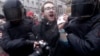 FILE - Riot policemen detain a journalist during a protest rally in St. Petersburg, Russia, March 26, 2017.