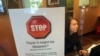 FILE - A sign warns of the dangers of measles in the reception area of a pediatrician's office in Scottsdale, Arizona, Feb. 7, 2015. 