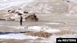 A screenshot from a video shows the disengagement process between Indian Army and China's People's Liberation Army from a contested lake area in the western Himalayas, in Ladakh region, India, Feb. 11, 2021. (Indian Army/Reuters TV/via Reuters)