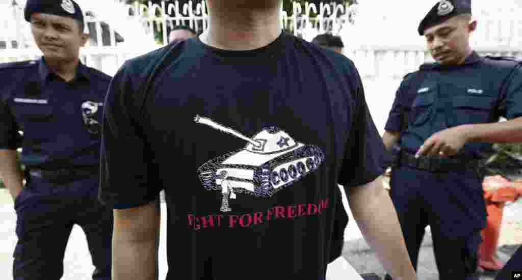 A protester wears a T-shirt with a tank during a protest in front of the Chinese Embassy in Kuala Lumpur, June 4, 2014.