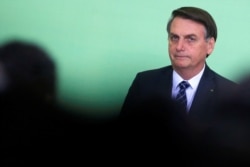 FILE - Brazil's President Jair Bolsonaro looks on during a ceremony at the Planalto Palace in Brasilia, Brazil, Nov. 12, 2019.