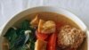 Linh Nguyen’s Vietnamese soup features fried tofu, tomatoes, a scattering of fresh herbs and some delicate poached crab and pork dumplings.