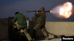 A member of Iraqi rapid response forces fires a rocket launcher during a battle with Islamic State militants in the district of Yarimja in southern Mosul, Iraq, Jan. 18, 2017.
