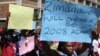 Zimbabweans hold placards during a protest against President Robert Mugabe government's handling of the economy in Harare, Zimbabwe, August 3, 2016.