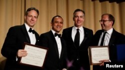 CNN's Jake Tapper, Evan Perez and Jim Sciutto, from left, accept the Merriman Smith Award from ABC News reporter Jonathan Karl at the White House Correspondents' Association dinner in Washington, April 28, 2018.