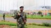 Uniformed police officer keeps guard after a huge fire left all flights suspended at the Jomo Kenyatta International Airport, in Kenya's capital Nairobi, August 7, 2013.