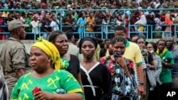 Mourners queue to pay their respects as the body of former President John Magufuli lies in state at Uhuru stadium in Dar es Salaam, Tanzania, March 20, 2021.