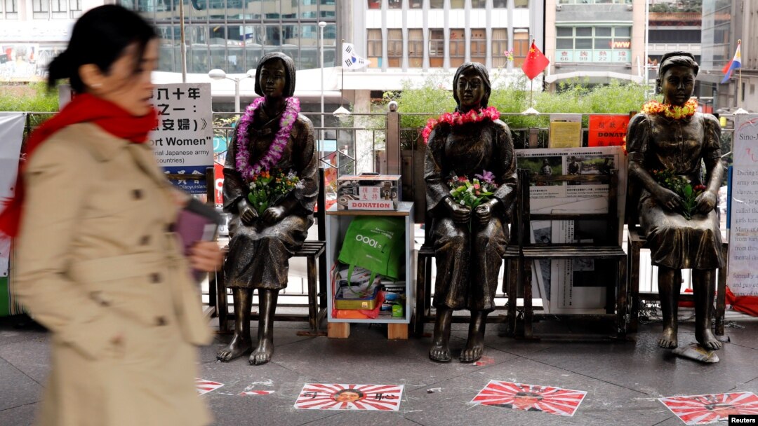 Statues of "comfort women" are placed outside Japan's consulate to commemorate the 80th anniversary of the Nanjing Massacre, in Hong Kong, China, Dec. 13, 2017. 
