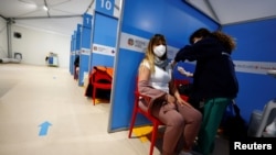 A medical worker injects the AstraZeneca coronavirus vaccine at Fiumicino Airport in Rome, Italy, March 8, 2021. 