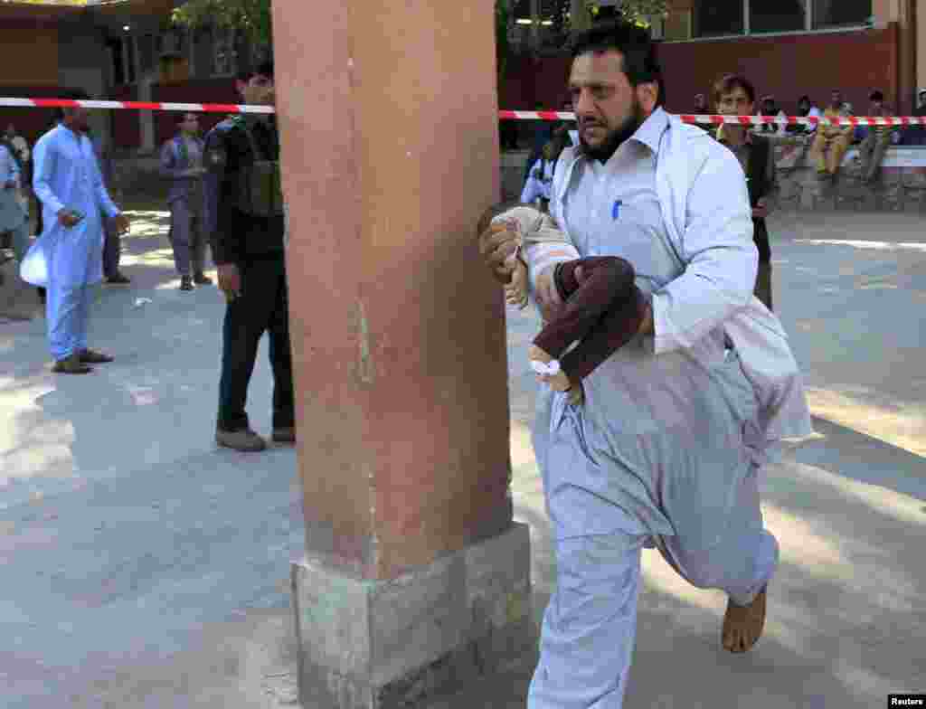 A rescue worker carries a child who was injured during an earthquake, at a hospital in Jalalabad, Afghanistan. A powerful earthquake struck a remote area of northeastern Afghanistan, shaking the capital Kabul, as shockwaves were felt in northern India and in Pakistan's capital, where hundreds of people ran out of buildings as the ground rolled beneath them.
