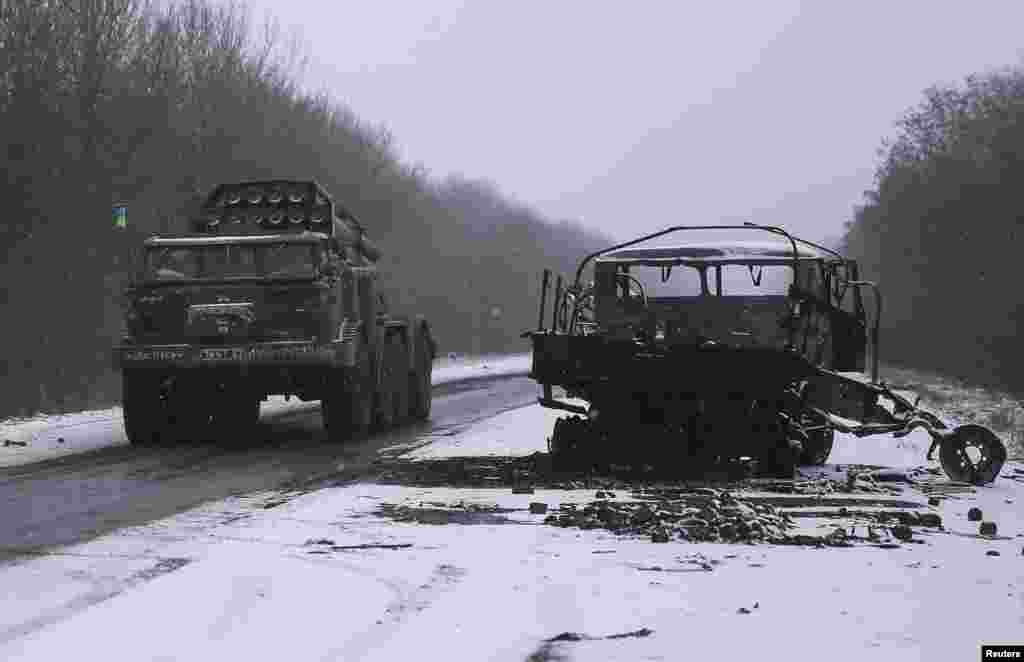 Ukrainian armed forces ride on a multiple rocket launcher system near Debaltseve, eastern Ukraine, Feb. 16, 2015.