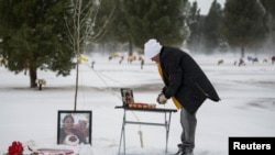 File - Antonio Cervantes brings gifts to the grave of his wife Gabriela, who died of the coronavirus disease (COVID-19), for Valentine's Day, at a cemetery in Santa Teresa, New Mexico, February 14, 2021.