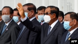 Cambodia's Prime Minister Hun Sen waves during King Norodom Sihamoni's departure to China for a health check-up at Phnom Penh International Airport in Phnom Penh on October 6, 2020. (Photo by TANG CHHIN Sothy/AFP)
