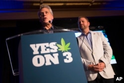 Jimmy Gould, co-founder of Responsible Ohio, a pro-marijuana legalization group, speaks to the crowd after a concession speech delivered by executive director Ian James, right, at an election night event at the Le Meridien hotel, Tuesday, Nov. 3, 2015.