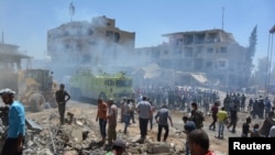 FILE - People inspect damage from bomb blasts claimed by Islamic State in Qamishli, Syria, July 27, 2016. Since early December 2019, IS has conducted at least three major attacks on Syrian government forces and allied militias in Deir el-Zour province.