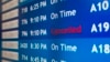 A departure board at the Philadelphia International Airport shows that US Airways Flight 796 to Tel Aviv has been canceled, July 22, 2014. 