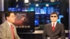 VOA's Huchen Zhang interviews blind Chinese activist Chen Guangcheng for VOA Mandarin's Wei Shi, January 31, 2013. (J. Featherly/VOA) 
