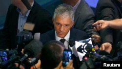 Swiss Attorney General Michael Lauber, center, speaks to media following a news conference in Bern, Switzerland, June 17, 2015. 