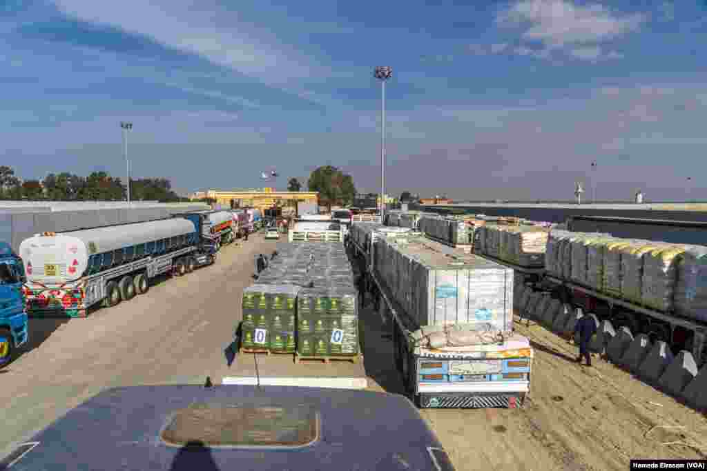 Gaza-bound trucks carrying water, medicine, food, fuel and other essentials wait at the Rafah crossing’s main gates on Jan. 19, 2025. U.N. officials say 80% of Gazans live in poverty after 15 months of Israeli bombardments and restrictions.