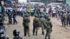 FILE - Ugandan army soldiers and police officers stand in front of a crowd during an opposition protest in Kampala, Uganda, Aug. 31, 2018.