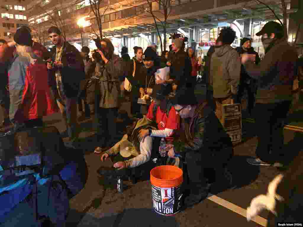 Some people were injured in a clash between protesters supporting President-elect Donald Trump and those opposing him. Some Trump hats were burned in protest.