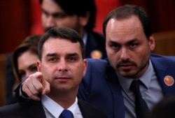 FILE - Flavio Bolsonaro, left, and Carlos Bolsonaro, sons of Brazil's President-elect Jair Bolsonaro (not pictured), are seen in Brasilia, Brazil, Dec. 10, 2018.