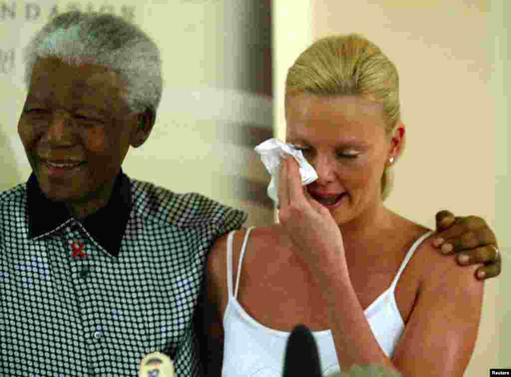 Oscar winning South African actress Charlize Theron weeps at her meeting with former South African President Nelson Mandela at the Nelson Mandela Foundation in Houghton, March 11,2004.