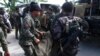 Philippine National Police (PNP) carry a body bag, containing a member of the Special Action Force, to a van in Mamasapano town, Maguindanao province, January 26, 2015.