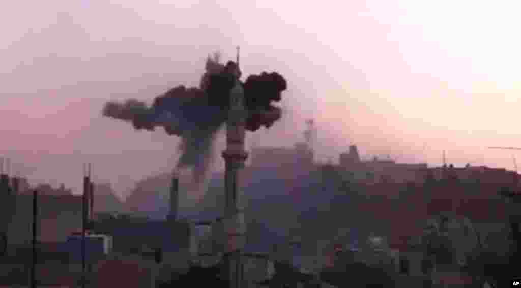 Black smoke from shelling is seen near Ali bin Abi Taleb mosque in Talbiseh, Homs, Syria, July 2, 2012. (AP/Ugarit News)