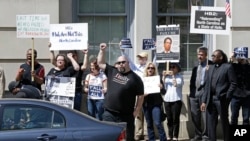 FILE - Opponents of House Bill 2 protest across the street from the North Carolina State Capitol in Raleigh, N.C., April 11, 2016.