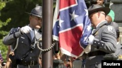 The Confederate battle flag is permanently removed from the South Carolina statehouse grounds during a ceremony in Columbia, South Carolina July, 10, 2015. 