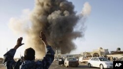 A rebel fighter reacts during an air strike in Ras Lanuf, March 7, 2011